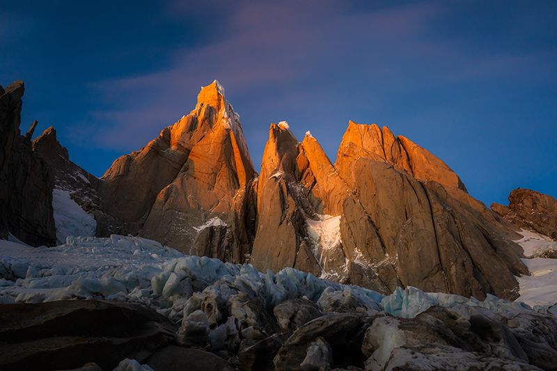 Warm light on rock peaks above glacier
