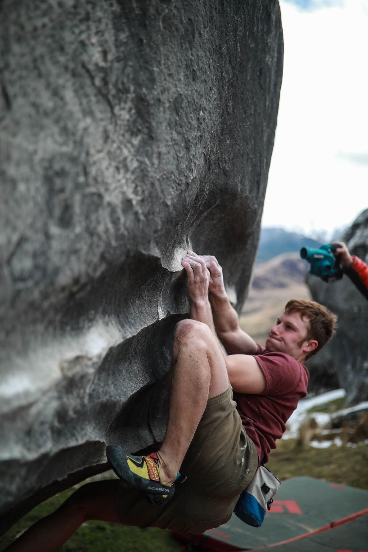 Climber on limestone boulder problem