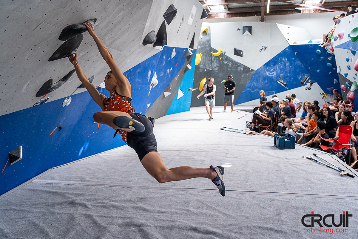 Female competitor on competition boulder problem