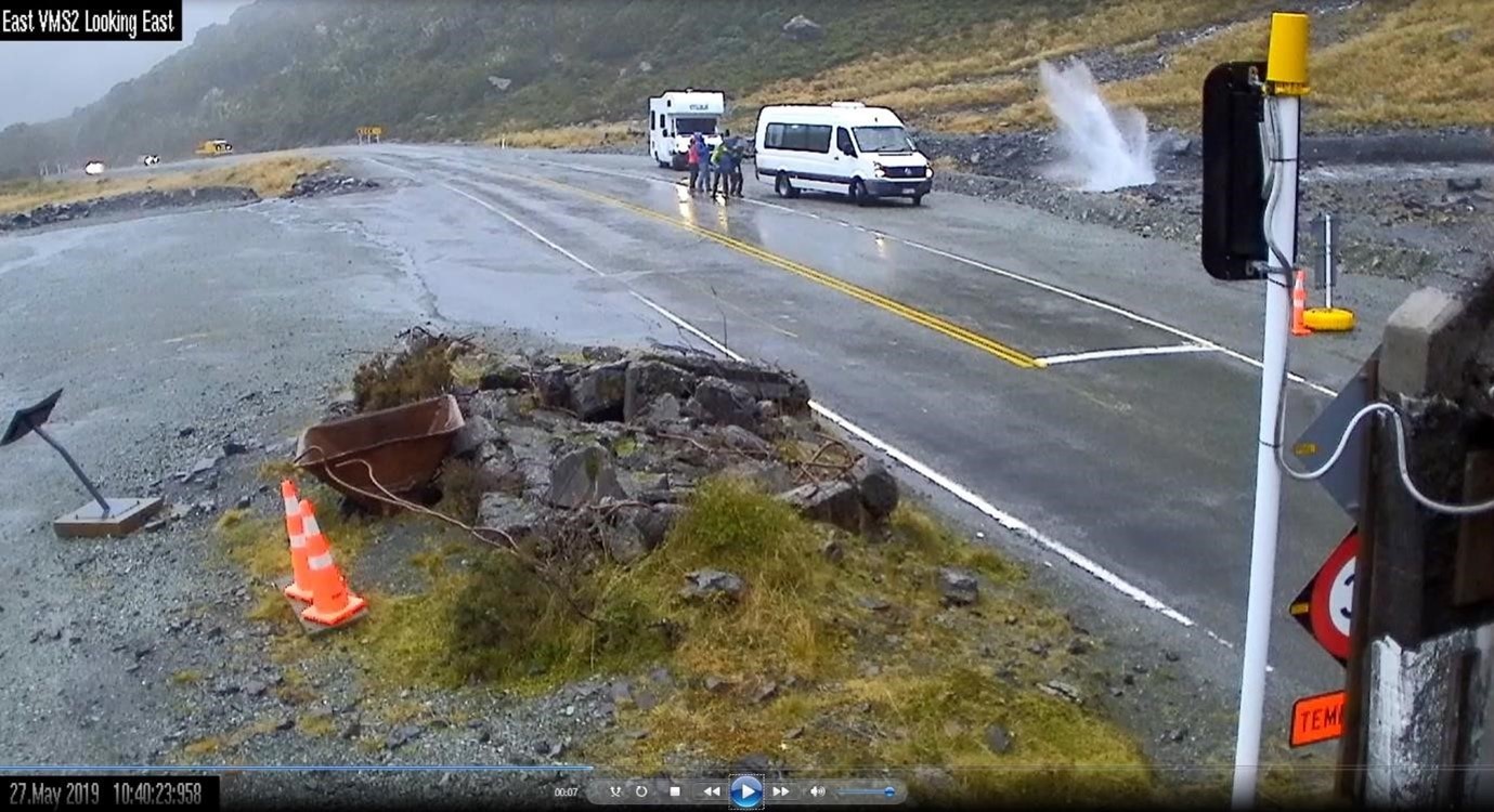 Still image taken from Milford Road Alliance's Homer Tunnel portal camera showing rockfall boulders impacting adjacent to the highway, narrowly missing road users. Occurance 27th May, 2019.