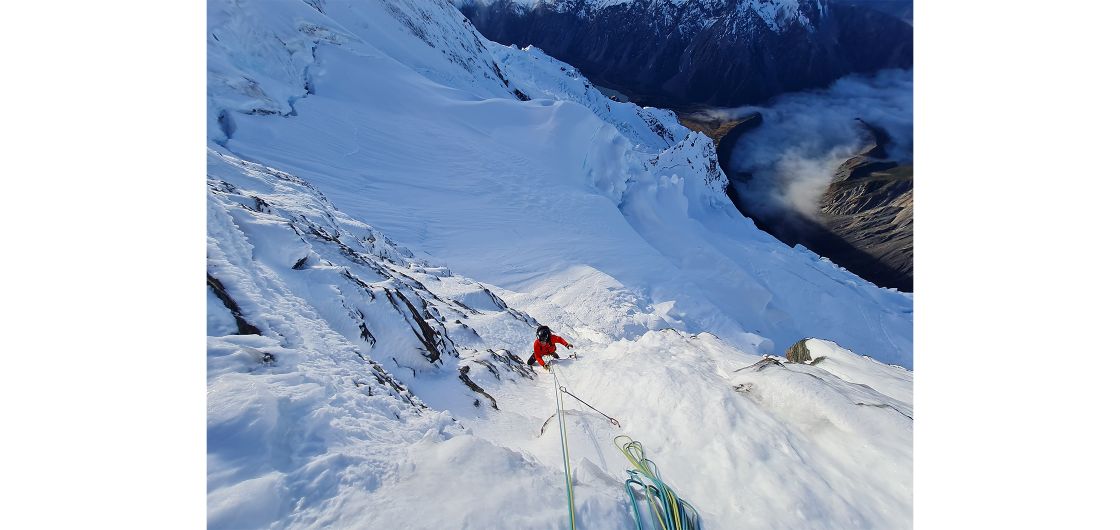 Climber on steep snow/ice face