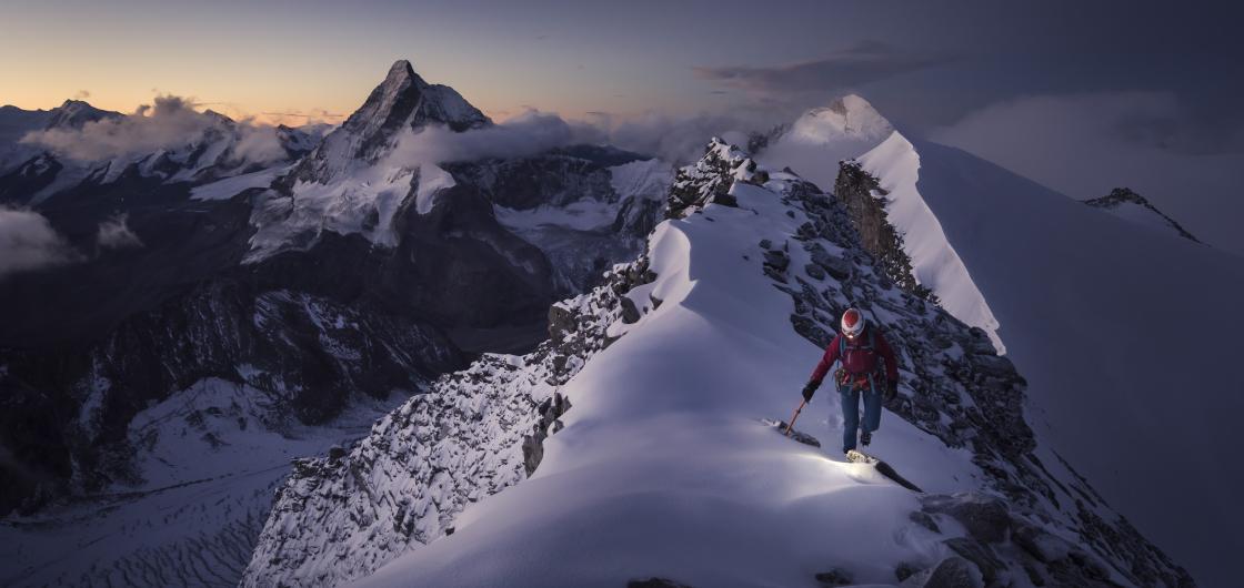 Climber on a mountain at sunrise