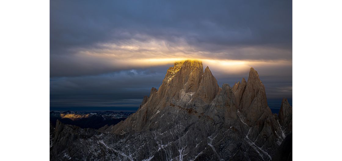 A halo of sunset gold wraps itself around the summit of Mt Fitzroy in Patagonia, Argentina. Photo: Derek Cheng Clouds and sun around a mountain top