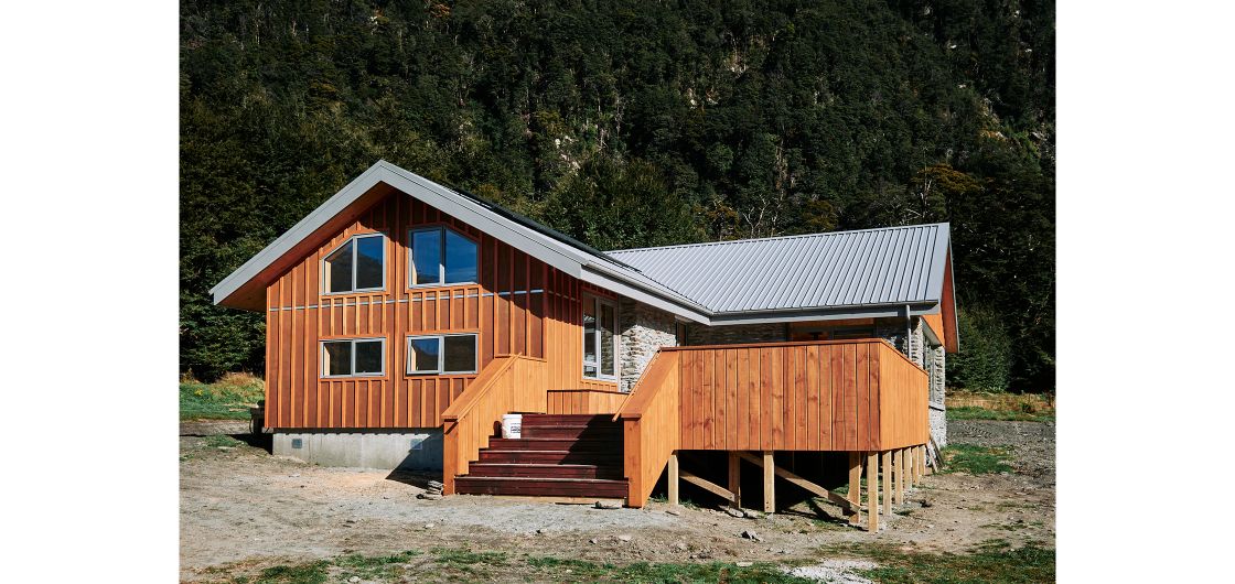 Timber and stone hut in forest setting