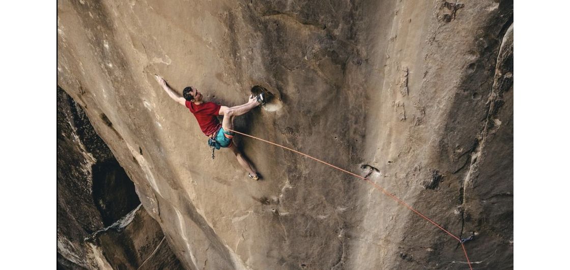Climber on crazy hard trad route