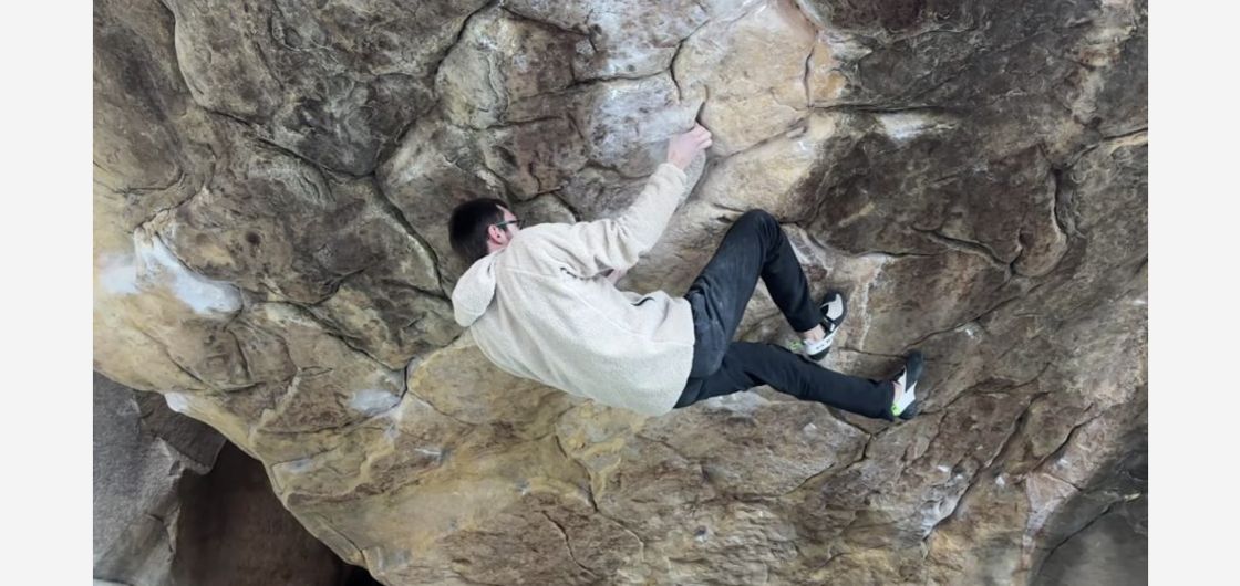 Climber on hard boulder