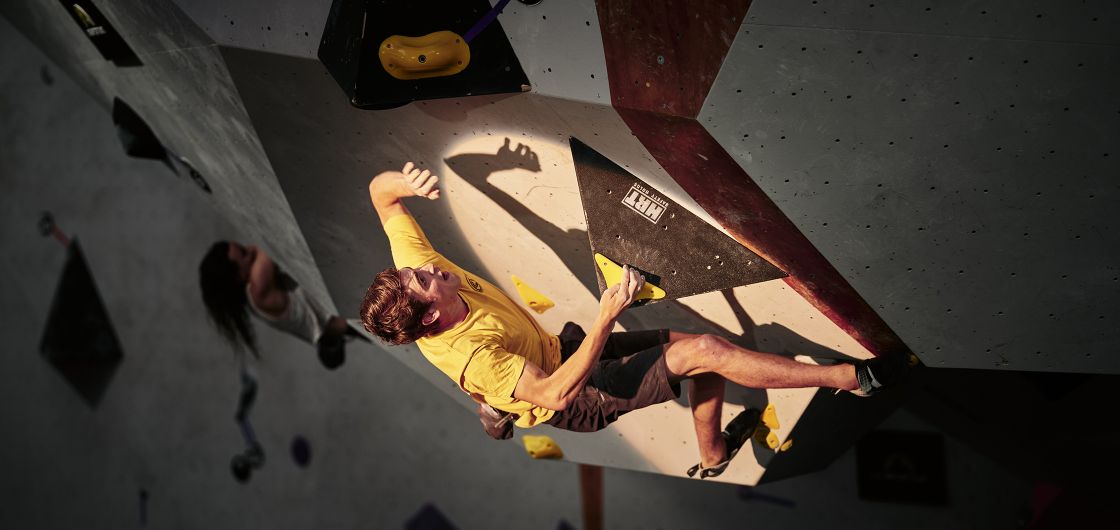 Competition climber on roof bloc