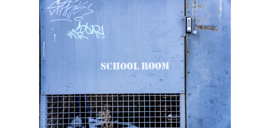 Blue cage door with stencil 'School Room'