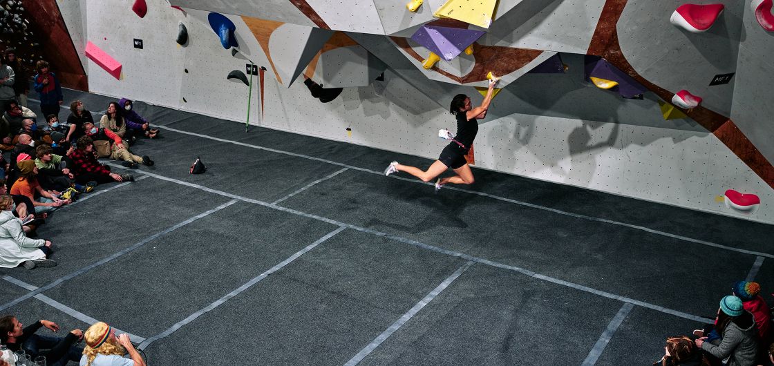 Cirrus Tan on finals problem three. Photo: Tom Hoyle Female climber on competition boulder problem