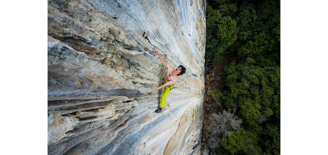 Rock climber clips carabiner