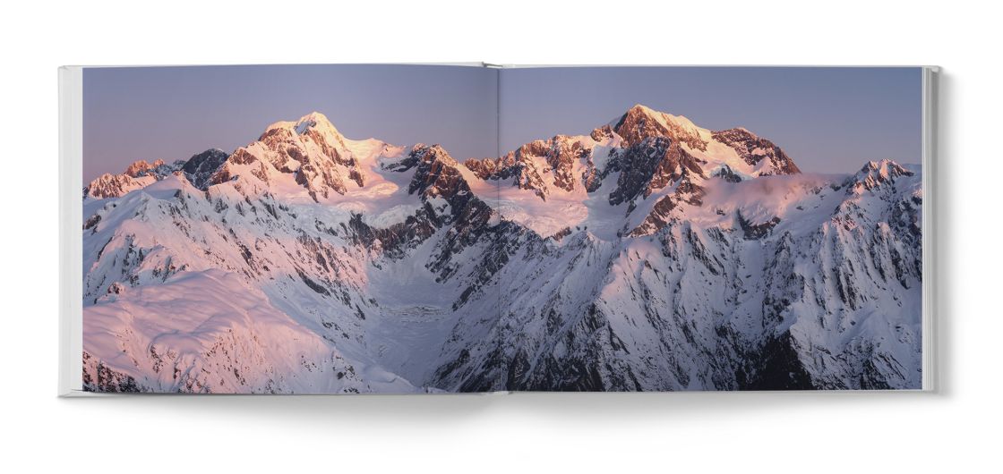 Book spread showing mountain photograph