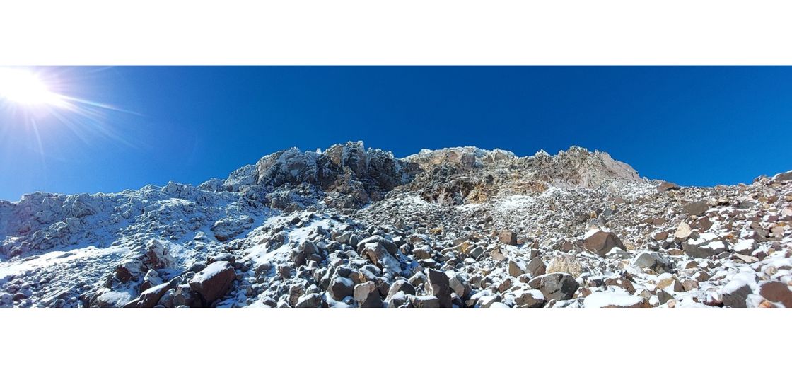 Boulder hopping with crampons on the the west side in May Icy mountainside