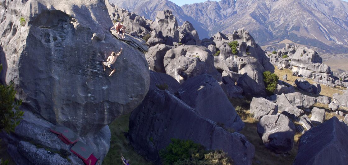 Climber on tall boulder