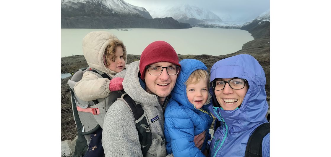 Family portrait in front of glacial lake