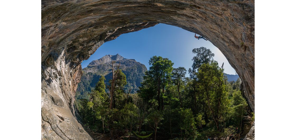 Perfect summers day climbing in Piopiotahi. Cesare Marchesin cruising on No Country For Old Men (29). Photo: Nat Warburton Fisheye view of climber in cave