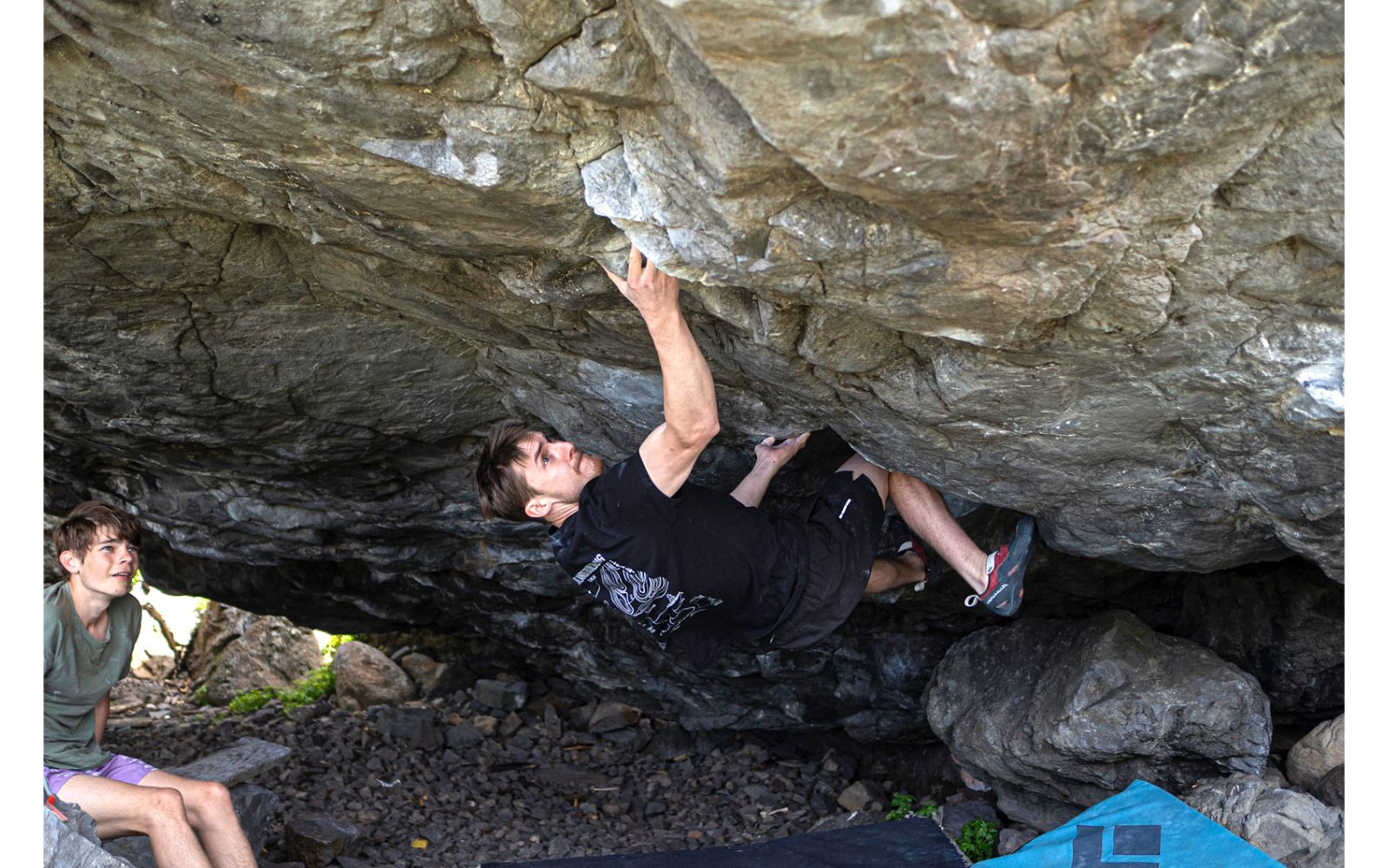 Boulderer on steep underside of boulder