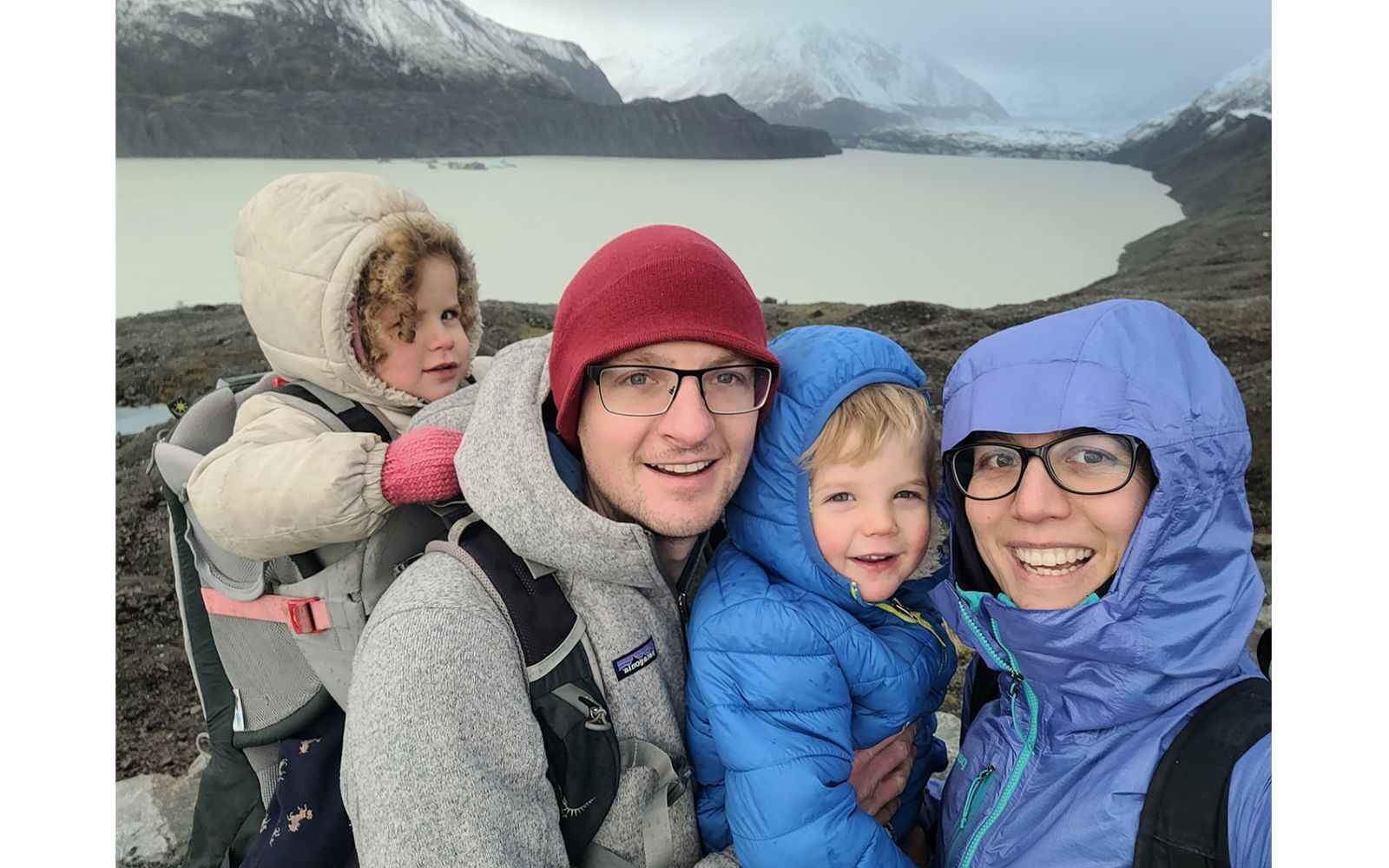 Family portrait in front of glacial lake