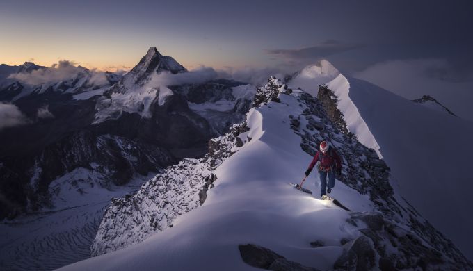 Climber on a mountain at sunrise