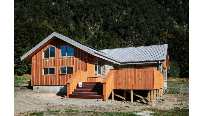 Timber and stone hut in forest setting