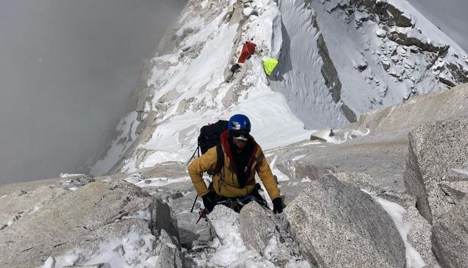 Alpine climber on exposed rockface