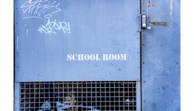 Blue cage door with stencil 'School Room'