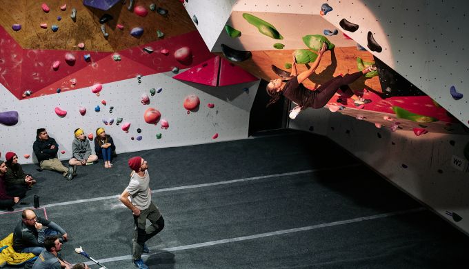 Female competitor on competition boulder problem