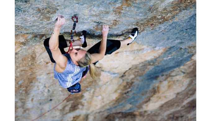 Femalew rock climber on terrifically hard route