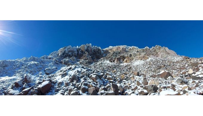 Boulder hopping with crampons on the the west side in May Icy mountainside