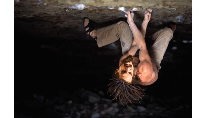 Climber expresses himself on steep rocks