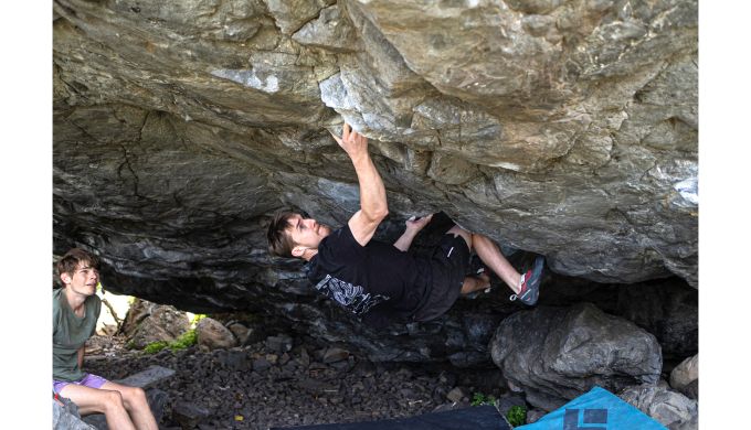 Boulderer on steep underside of boulder