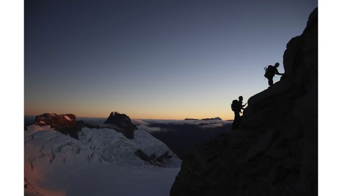 Silhouetted climbers