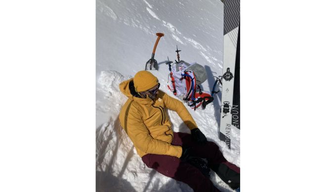 Climber sitting on snowy slope