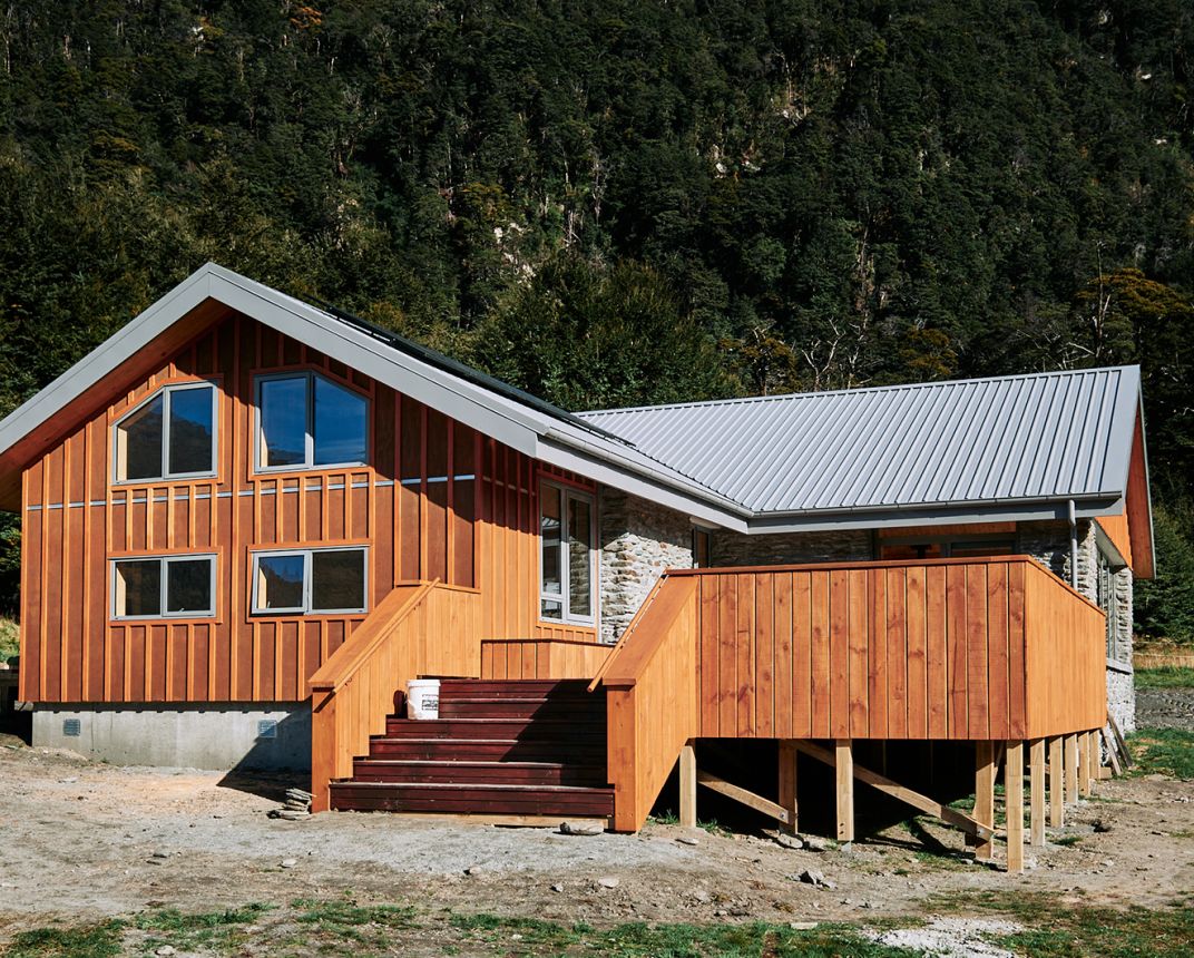 Timber and stone hut in forest setting