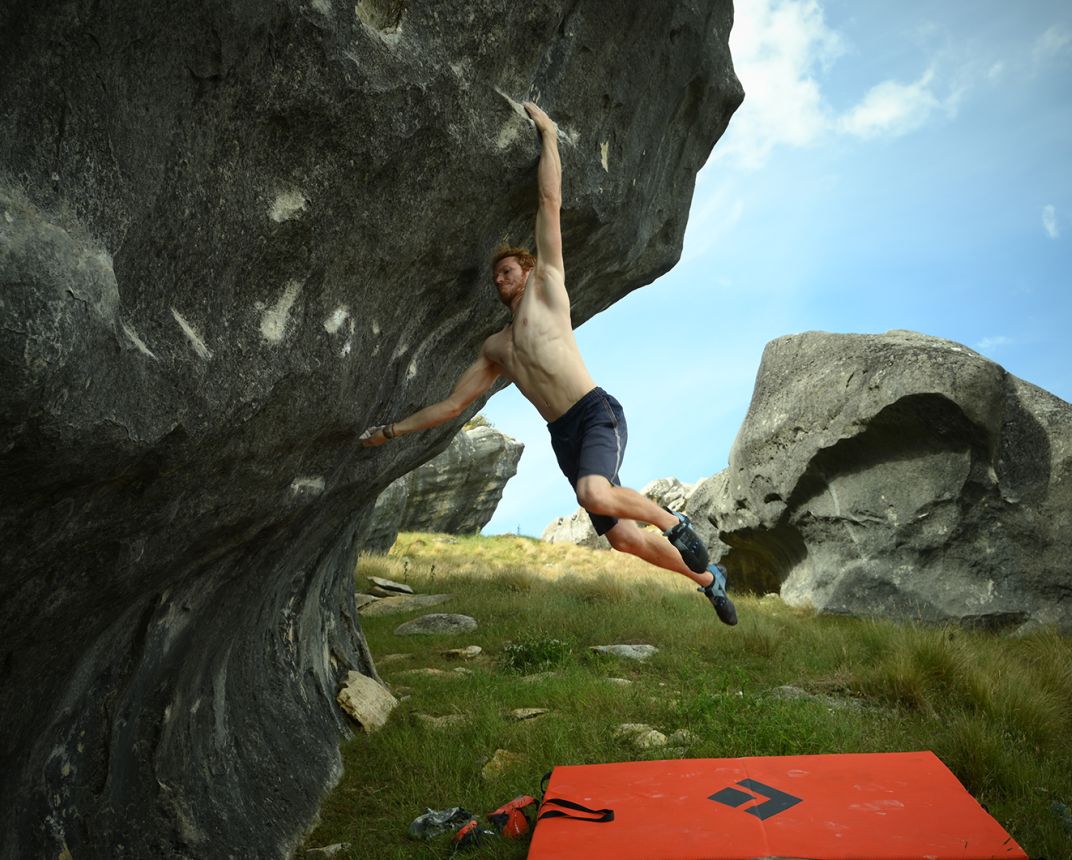 Boulderer jumping