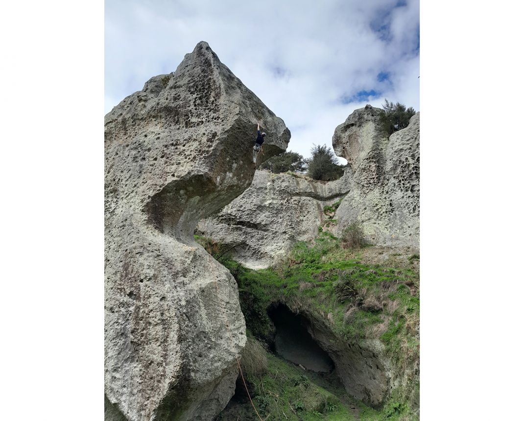 Climber on absurdly-shaped rock formation