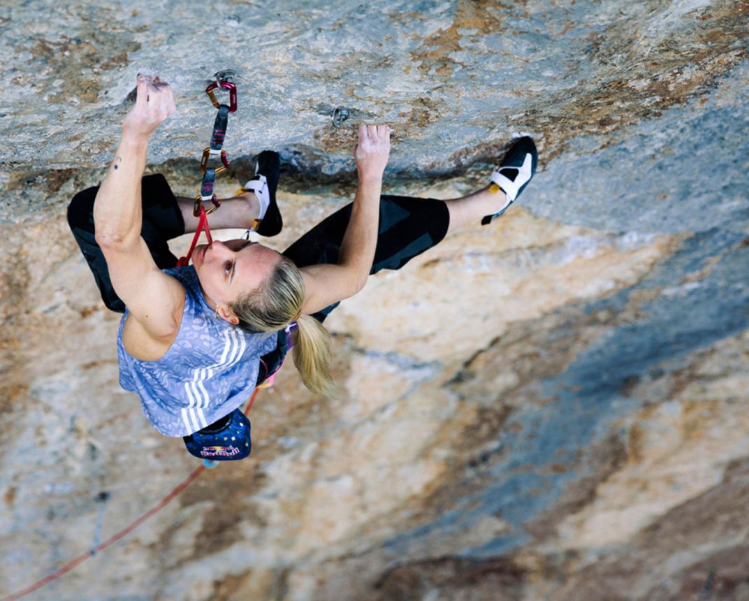 Femalew rock climber on terrifically hard route