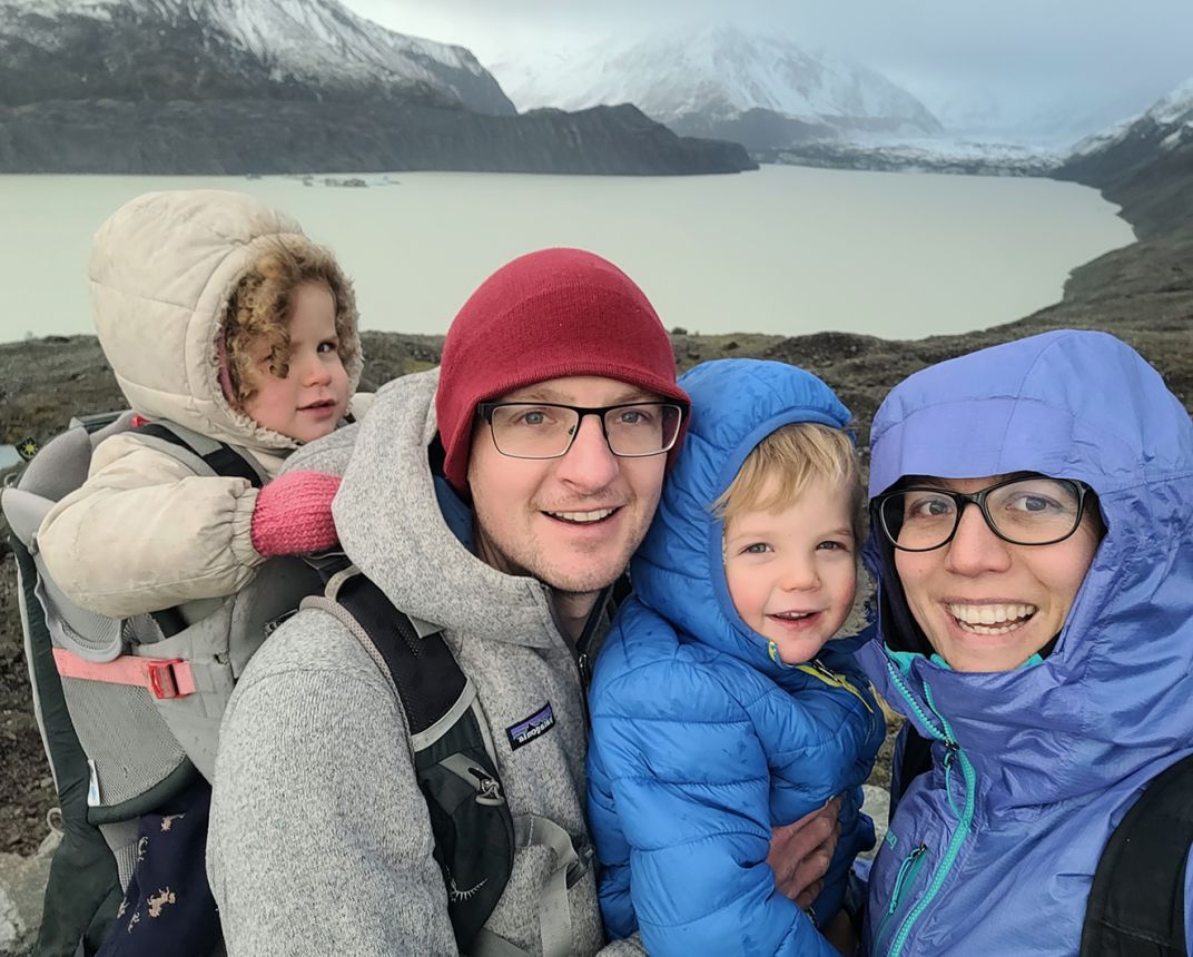 Family portrait in front of glacial lake