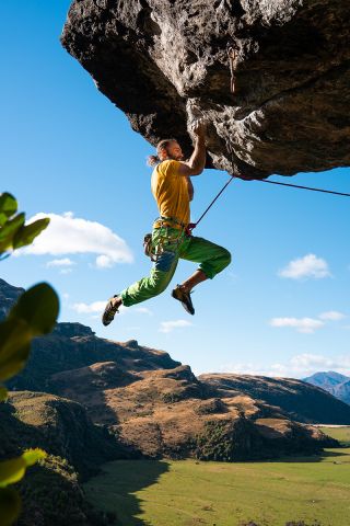 climber hanging from rock