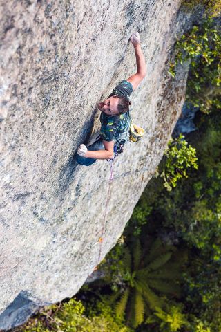 looking down at man climbing on rock