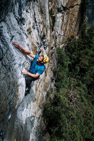 man climbing on rock