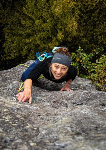 Climber climbs route on ignimbrite pinnacle