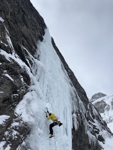 Ice climber on frozen waterfall