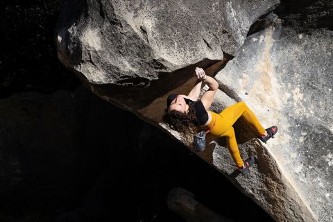 Boulderer on steep boulder