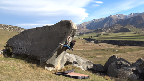 Climber on compression boulder