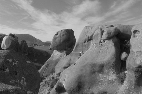 Climber on tall boulder