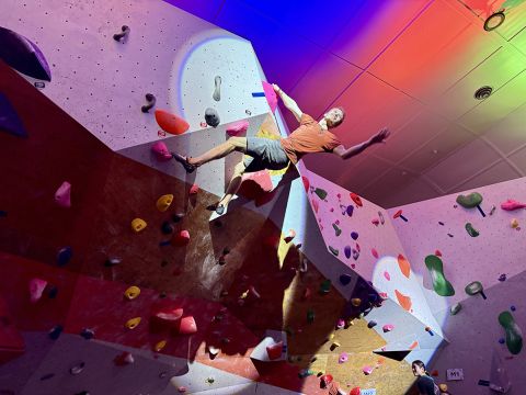 Competition climber on bloc
