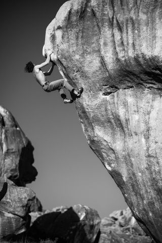 boulderer on high rock