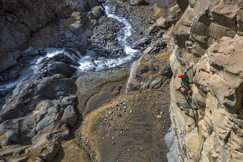 Climber on rock with river below