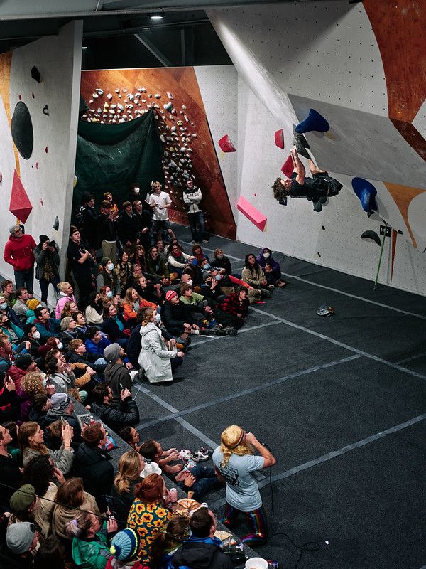 Male competitor on competition boulder problem