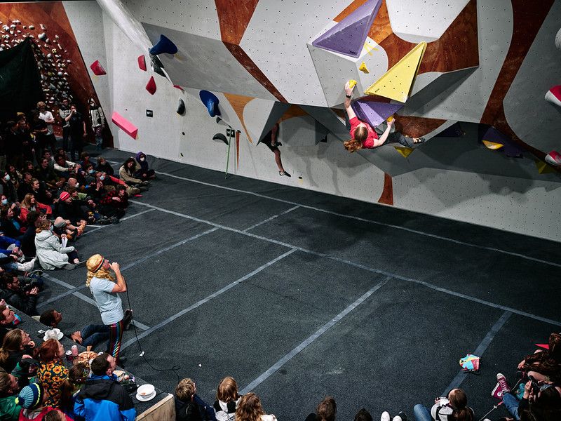 Female competitor on competition boulder problem